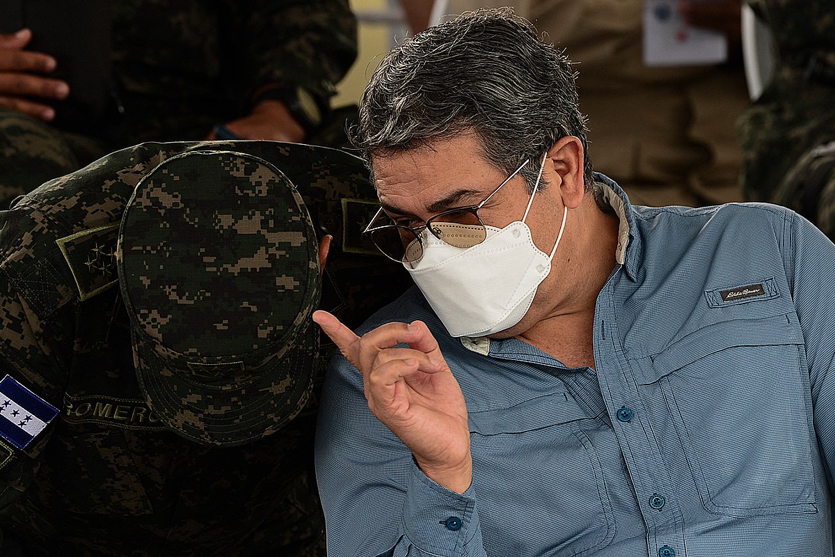 Honduran President Juan Orlando Hernandez gives instructions to an army colonel, after delivering a speech during the eighth anniversary of the Military Police of Public Order (PMOP) in Tegucigalpa, on August 24, 2021. Photo by ORLANDO SIERRA/AFP via Getty Images
