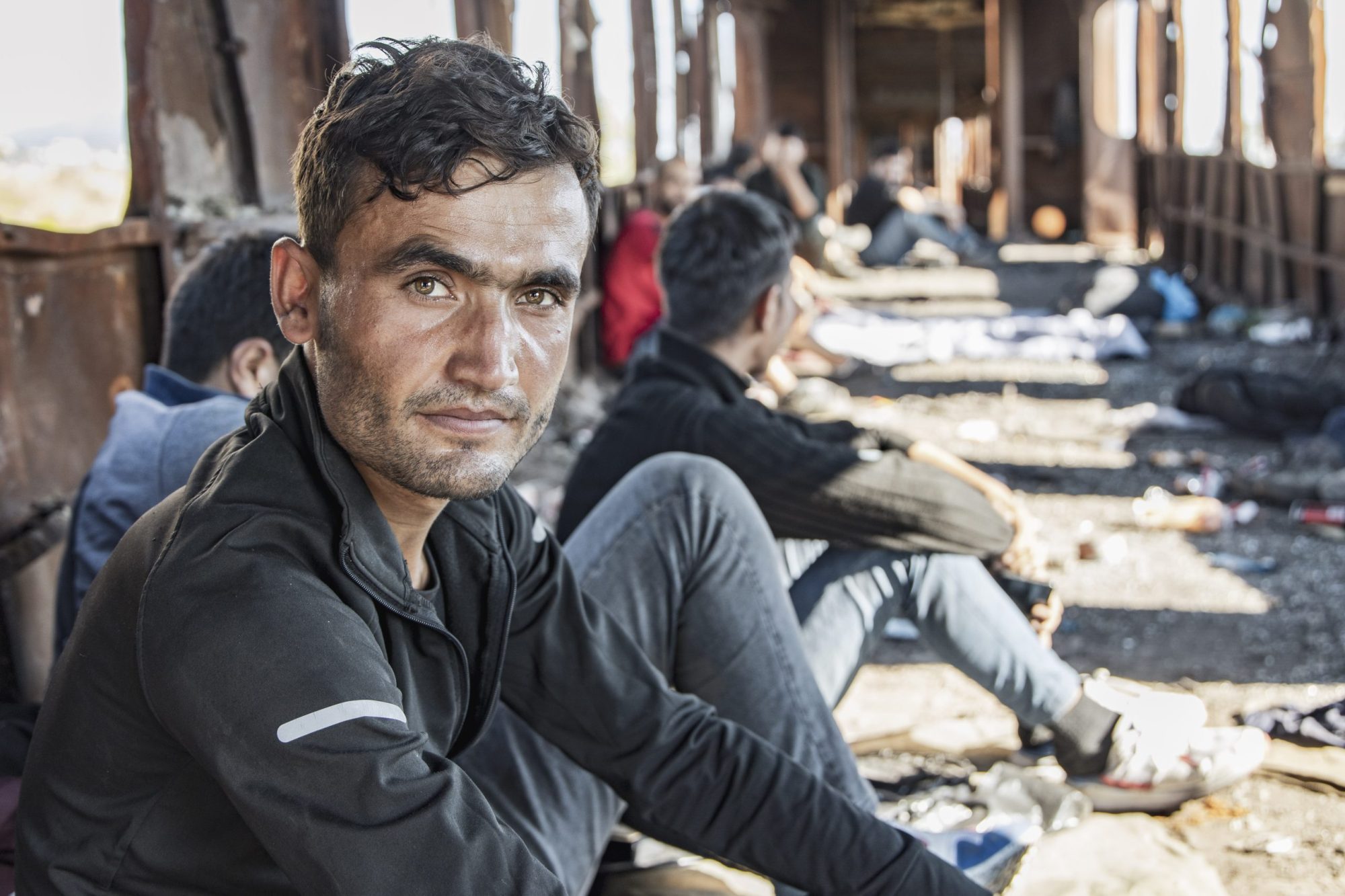 Male asylum seekers as seen in abandoned old train carriages
