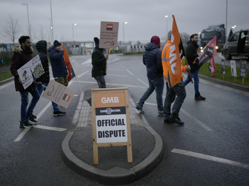 people walking with signs