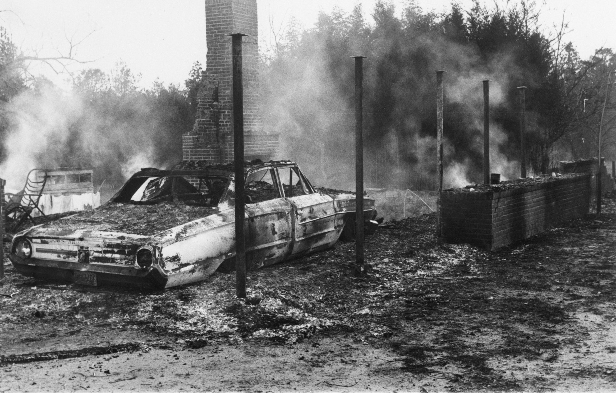 Historical photograph of Black civil rights leader Vernon Dahmer's home and grocery store, which were destroyed by the KKK in a bombing attack on January 10, 1966.