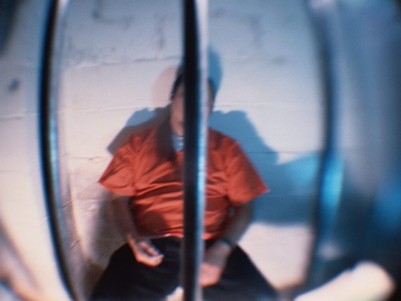 Prisoner Behind Bars of Cell. Photo by Steven Puetzer via Getty Images