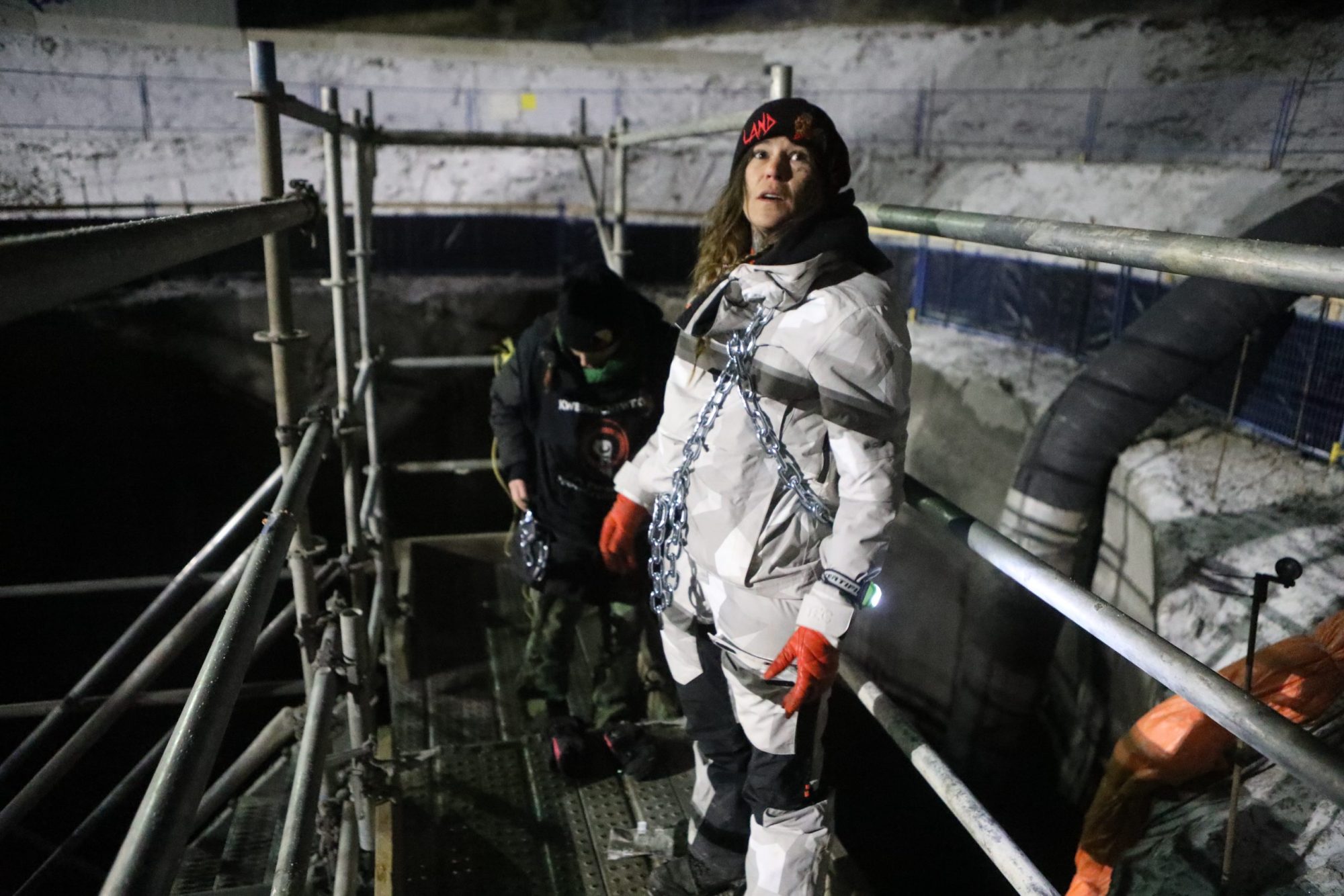 Land defenders Cassie Fox and Khursten Bullock chain themselves to scaffolding at the site of the Trans Mountain Pipeline Expansion (TMX) project's development at Pipsell in Secwepemcul'ecw, on Dec. 10, 2023.