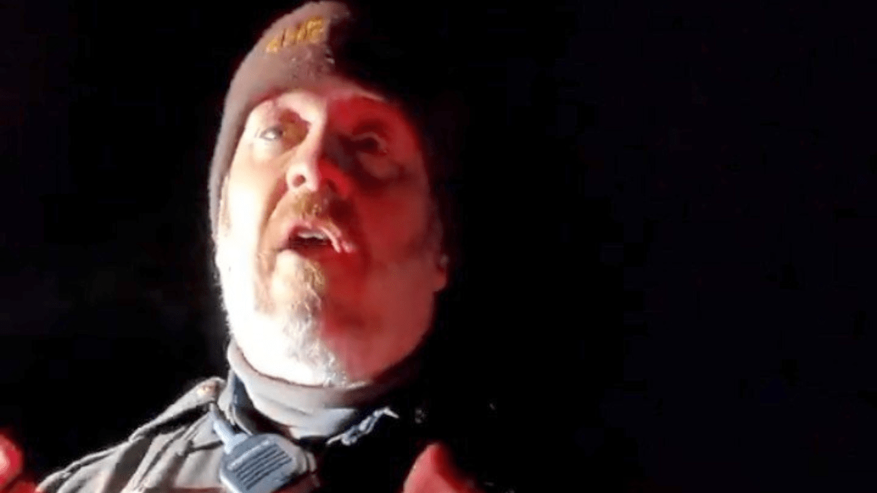 Close-up of a bearded police officer wearing a beanie